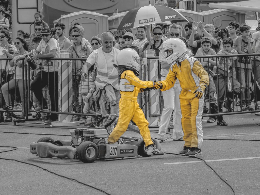 Two young drivers shaking hands